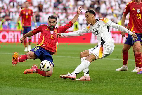 Dani Carvajal and Jamal Musiala vie for the ball